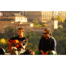 スペイン、アルハンブラ宮殿の前で「アルハンブラ宮殿の思い出」を弾いている。
