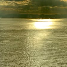 夕焼けに映える黄金色の江の島の海